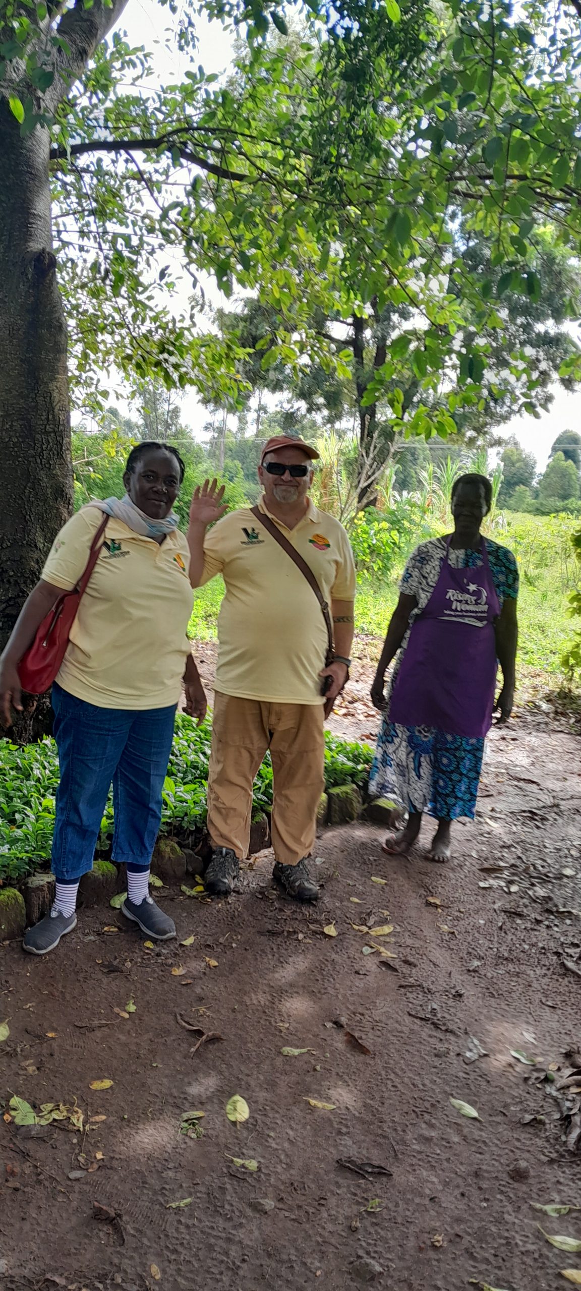 Women Grow Uganda field staff with a farmer during a village visit